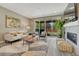 Modern living room with a cozy sofa, decorative fireplace, and large sliding glass doors for seamless indoor-outdoor living at 177 Vista Cliff Cir, Castle Rock, CO 80104
