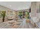 Bright living room featuring neutral decor, a stylish fireplace, and sliding glass doors to the outdoor space at 177 Vista Cliff Cir, Castle Rock, CO 80104