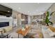 Open living room featuring a fireplace, and stylish decor with an adjacent modern kitchen at 177 Vista Cliff Cir, Castle Rock, CO 80104