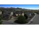 Aerial view of a neighborhood highlighting a two-story home with mountain views at dusk at 10448 Kicking Horse Dr, Littleton, CO 80125