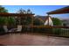 Open back deck with wooden pergola and chairs overlooking the beautiful green trees at 10448 Kicking Horse Dr, Littleton, CO 80125