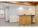 Basement bar features knotty pine wood, a tile floor, and includes a sink, mini fridge, and shelving at 10448 Kicking Horse Dr, Littleton, CO 80125