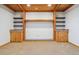 Basement room with carpet and built-in wooden shelving units with cabinets and stone countertops at 10448 Kicking Horse Dr, Littleton, CO 80125