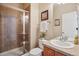 Bathroom featuring a glass-enclosed shower with stylish tile work, a toilet, and a vanity with sink at 10448 Kicking Horse Dr, Littleton, CO 80125