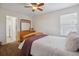 Bright bedroom with a plush bed, wooden dresser, and window offering natural light and an open doorway at 10448 Kicking Horse Dr, Littleton, CO 80125
