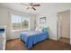 Sunlit bedroom with a cozy bed, large window, and neutral decor at 10448 Kicking Horse Dr, Littleton, CO 80125