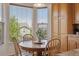 Cozy breakfast nook with large windows, a wooden table, and matching chairs next to the kitchen at 10448 Kicking Horse Dr, Littleton, CO 80125