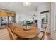 Eat-in kitchen area with a wooden table and chairs, seamlessly connects to the kitchen and living area at 10448 Kicking Horse Dr, Littleton, CO 80125