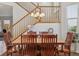 Dining area under staircase with traditional wooden table, chandelier, and side table at 10448 Kicking Horse Dr, Littleton, CO 80125