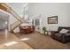 Bright dining area with hardwood floors and staircase, perfect for Gathering meals and entertaining guests at 10448 Kicking Horse Dr, Littleton, CO 80125