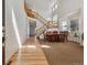 Bright entryway featuring hardwood floors, a staircase, and a formal dining area at 10448 Kicking Horse Dr, Littleton, CO 80125