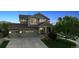 Exterior elevation of a two-story home featuring a well-kept lawn and a three-car garage at 10448 Kicking Horse Dr, Littleton, CO 80125