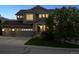 Charming two-story home with a well-manicured lawn, three-car garage, and inviting front porch at 10448 Kicking Horse Dr, Littleton, CO 80125
