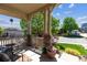 Inviting covered front porch with stone pillars, offering a cozy outdoor seating area at 10448 Kicking Horse Dr, Littleton, CO 80125