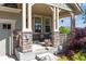Charming front porch adorned with stone pillars and space for seating at 10448 Kicking Horse Dr, Littleton, CO 80125