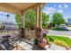 Inviting covered front porch with stone pillars, offering a cozy outdoor seating area at 10448 Kicking Horse Dr, Littleton, CO 80125