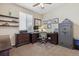 Comfortable home office with dark wood furniture, carpeted floors, a ceiling fan, and natural light at 10448 Kicking Horse Dr, Littleton, CO 80125