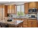 Bright kitchen with wood cabinets, granite countertops, stainless appliances, and a window with natural light at 10448 Kicking Horse Dr, Littleton, CO 80125