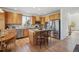 Updated kitchen features an island with bar seating, stainless steel appliances, and beautiful wood cabinets at 10448 Kicking Horse Dr, Littleton, CO 80125