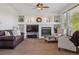 Cozy living room with a fireplace, built-in shelving, and comfortable seating at 10448 Kicking Horse Dr, Littleton, CO 80125