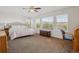 Spacious main bedroom with natural light, carpet floors, and scenic views through large windows at 10448 Kicking Horse Dr, Littleton, CO 80125