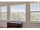 Windows showcase stunning views of the mountains and nearby neighborhood from an upstairs room at 10448 Kicking Horse Dr, Littleton, CO 80125