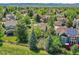 An aerial view showing the home with solar panels in a lush green neighborhood at 848 Huntington Pl, Highlands Ranch, CO 80126