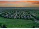 Vibrant aerial view of a suburban neighborhood with green spaces and mountain backdrop at 848 Huntington Pl, Highlands Ranch, CO 80126
