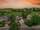 Stunning aerial view of home showcasing verdant surroundings and neighborhood, captured at sunset at 848 Huntington Pl, Highlands Ranch, CO 80126