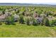 Expansive aerial view of the suburban neighborhood, highlighting the lush greenery and serene mountain backdrop at 848 Huntington Pl, Highlands Ranch, CO 80126