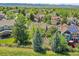 An aerial view showcasing the location in a lush green neighborhood and mountain view at 848 Huntington Pl, Highlands Ranch, CO 80126