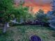 Spacious backyard featuring a well-maintained lawn, mature trees, a deck, and outdoor entertainment space at 848 Huntington Pl, Highlands Ranch, CO 80126