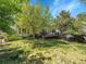 Spacious backyard featuring a deck, lush lawn, and mature trees at 848 Huntington Pl, Highlands Ranch, CO 80126