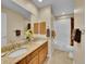 Bathroom featuring double sinks with granite countertops, wood cabinets, and a shower and tub at 848 Huntington Pl, Highlands Ranch, CO 80126