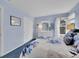 Serene bedroom featuring white furnishings, soft blue walls, and large window at 848 Huntington Pl, Highlands Ranch, CO 80126