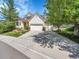 Inviting home featuring a well-manicured lawn, three-car garage, and lovely landscaping at 848 Huntington Pl, Highlands Ranch, CO 80126