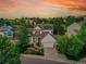 Charming two-story home with a well-maintained lawn and a solar panel, in a Gathering-friendly neighborhood, at sunset at 848 Huntington Pl, Highlands Ranch, CO 80126