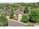 A residential property with a well-maintained front yard, mature trees, and a manicured lawn at 848 Huntington Pl, Highlands Ranch, CO 80126