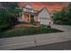 Attractive home featuring lush landscaping, an inviting entryway, and a well-maintained front yard at 848 Huntington Pl, Highlands Ranch, CO 80126