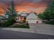 Charming home with a manicured lawn, beautiful landscaping, a two-car garage, and an inviting entryway at 848 Huntington Pl, Highlands Ranch, CO 80126