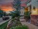 Home featuring mature trees, terraced landscaping, and a charming entryway leading to the front door at 848 Huntington Pl, Highlands Ranch, CO 80126