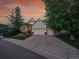 Beautiful home with a well-manicured lawn, mature tree, two-car garage, and classic architectural details at 848 Huntington Pl, Highlands Ranch, CO 80126
