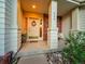 Charming front porch with decorative pillars, a wreath-adorned door, and a cozy sitting area at 848 Huntington Pl, Highlands Ranch, CO 80126