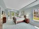 Serene main bedroom with large windows, tray ceiling, and soft blue carpet at 848 Huntington Pl, Highlands Ranch, CO 80126