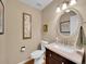 Cozy powder room featuring wood floors, sink, and framed artwork at 848 Huntington Pl, Highlands Ranch, CO 80126