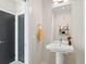 Stylish powder room featuring a pedestal sink, modern fixtures, and ample natural light at 4917 Lowell Blvd # 105, Denver, CO 80221