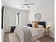 Inviting bedroom with a ceiling fan, large window, stylish decor, and plush carpeting at 4917 Lowell Blvd # 105, Denver, CO 80221