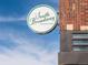 South Broadway Country Club sign against a blue sky, mounted on a brick building at 4917 Lowell Blvd # 105, Denver, CO 80221