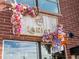 Ornate floral arrangement framing the Lariat business sign on a brick wall at 4917 Lowell Blvd # 105, Denver, CO 80221