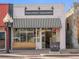 Charming High Point Creamery storefront with a striped awning and inviting bench at 4917 Lowell Blvd # 105, Denver, CO 80221